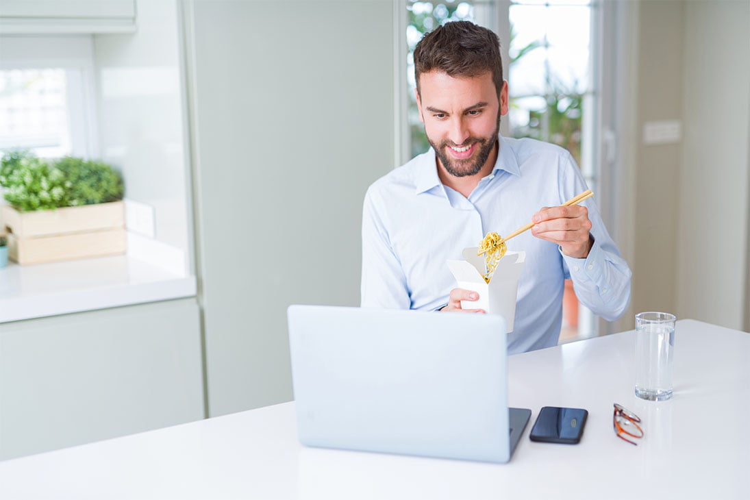 Business man eating take away asian noodles food while working u NoonPi Lunchtime Webinars